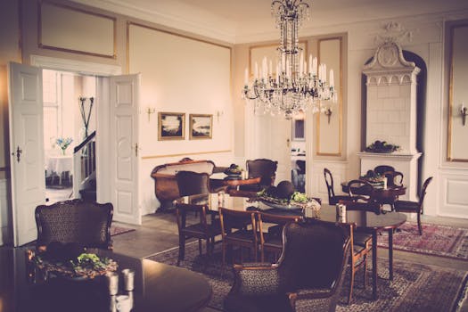 A vintage-style dining room showcasing a grand chandelier and classic furniture design.
